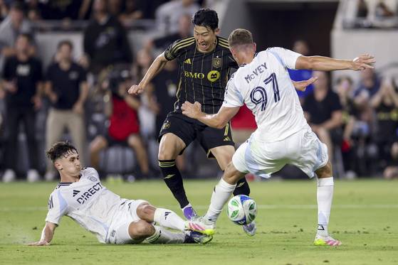 상대 수비수 2명 사이로 돌파를 시도하는 손흥민(가운데). AP=연합뉴스