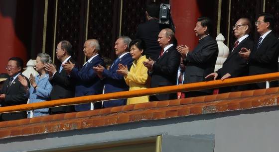 Former South Korean President Park Geun-hye, center in yellow, is seen clapping at a military parade at Tiananmen Square in Beijing, China, on Sept. 3, 2015, to commemorate the 70th anniversary of China's Victory Day. [JOINT PRESS CORPS]
