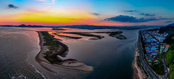 지난달 31일 부산 낙동강 하구에 해가 지고 있다. 쇠제비갈매기 서식지인 도요등이 맨 앞에 보인다. 전문가들은 “과거 7000~8000마리가 찾던 때로 되돌릴 수는 없지만, 낙동강 하구는 여전히 쇠제비갈매기 서식지로서 가치가 있다”며 복원의 중요성을 강조한다. 이원준 기자 windstorm@kookje.co.kr