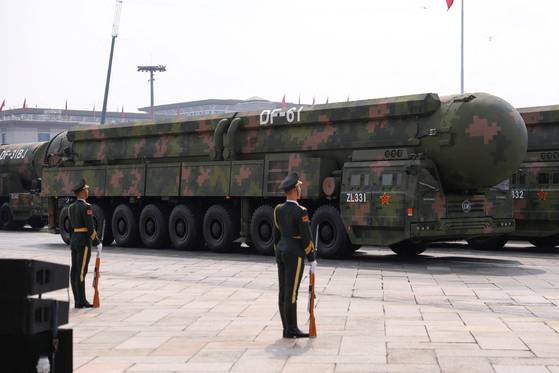 Members of the People's Liberation Army stand as the strategic strike group displays DF-61 nuclear missiles during a military parade to mark the 80th anniversary of the end of World War II in Beijing on Sept. 3. [REUTERS/YONHAP]