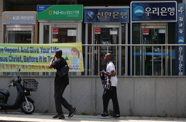 2024년 7월 14일 서울시내에 설치된 주요 은행들의 현금인출기 앞으로 외국인들이 지나가고 있다. 연합뉴스
