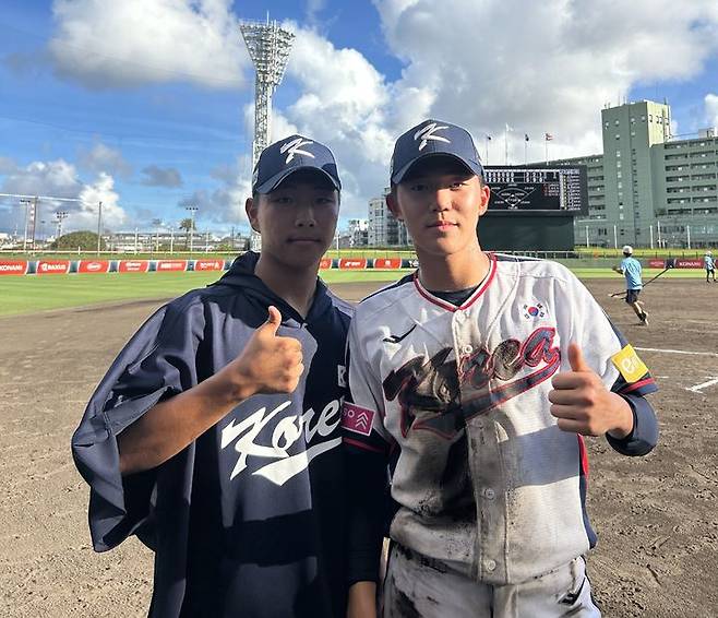 [서울=뉴시스] 18세 이하(U-18) 한국 야구 대표팀 최요한(왼쪽)과 박지호가  5일 일본 오키나와의 셀룰러 나하 스타디움에서 열린 대회 1차전에서 푸에르토리코를 상대로 5-2로 승리한 뒤 기념사진을 찍고 있다. (사진=대한야구소프트볼협회 제공) 2025.09.05. *재판매 및 DB 금지