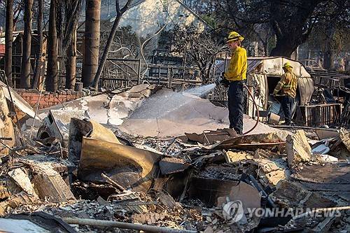 LA 이튼 지역에서 잔불 진화 중인 소방관들 [로이터=연합뉴스 자료사진]