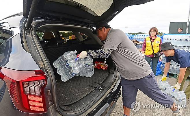 단수 앞두고 강릉시민에게 보급하는 생수 (강릉=연합뉴스) 유형재 기자 = 5일 강원 강릉시 강남동 강남축구공원에서 주민들에게 생수를 나눠주고 있다.
    강릉시는 수돗물 사용을 조금이라도 줄이고자 저수율 10% 이하에 배부하기로 했던 218만개의 생수를 1인당 12ℓ씩 배부하고 있다. 2025.9.5 yoo21@yna.co.kr