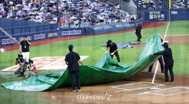 2025 신한 SOL Bank KBO리그 두산 베어스 대 LG 트윈스 경기가 6일 서울 잠실야구장에서 열렸다  경기 전 갑자기 쏟아지는 비에 구장 관리인들이 방수포를 씌우고 있다. /사진=김진경 대기자
