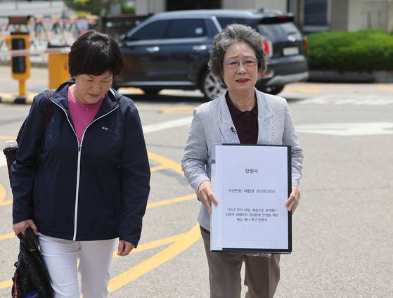 1964년 성폭력에 대항하는 과정에서 '고의에 의한 상해'로 구속 수사 및 유죄 판결을 받은 최말자씨가 2023년 5월 31일 오후 대법원 앞에서 정당방위 인정을 위한 재심 개시 촉구 탄원서를 제출하기 위해 이동하고 있다. 최말자 할머니 옆은 그의 조력자인 윤향희씨. 연합뉴스