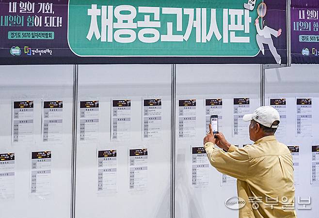 고양시 일산서구 킨텍스 제1전시장에서 열린 '경기도 5070 일자리박람회'를 찾은 한 시민이 채용게시판을 촬영하고 있다. 임채운기자
