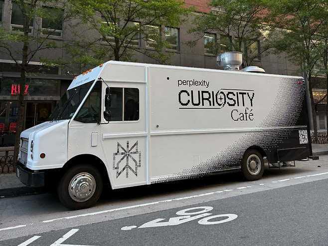 Perplexity’s Curiosity Cafe truck toured New York City during Tech Week in June, offering free coffee to anyone who showed the app, with extras for Pro users. Like its Seoul cafe, the mobile pop-up was part of the company’s push to introduce AI through everyday, physical interactions. (Perplexity)