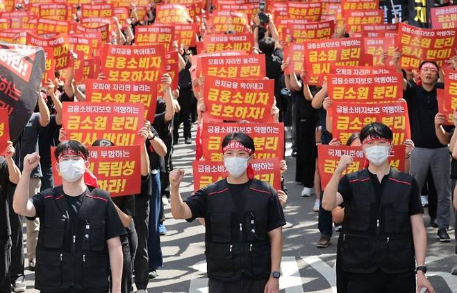 18일 서울 영등포구 여의도 국회의사당역 앞에서 열린 금융감독원 금융소비자보호원 분리 및 금융감독원 공공기관 지정 반대 집회에서 금감원 노동조합원들이 구호를 외치고 있다. 연합뉴스