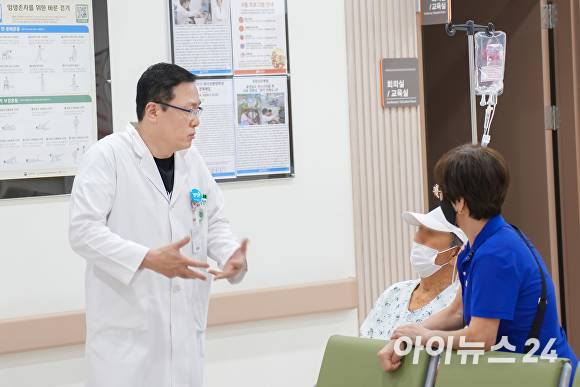 신경외과 김효창 과장이 치료전 환자와 이야기 하고 있다. [사진=포항성모병원]