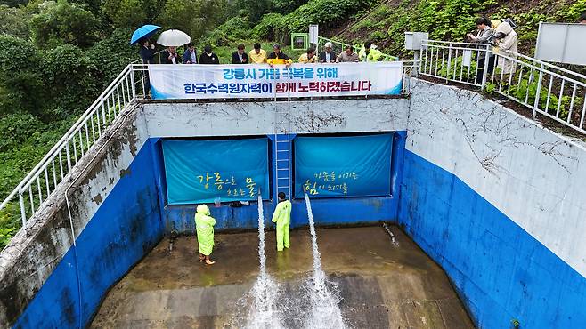한국수력원자력(주) 관계자와 강릉시청 공무원들이 지난 20일 강릉시 성산면 남대천 상류에 있는 도암댐 방류구를 통해 물이 흘러나오는 모습을 바라보고 있다. 도암댐 방류는 2001년 수질 문제 등으로 중단된 이후 24년 만이다. 강릉시 제공