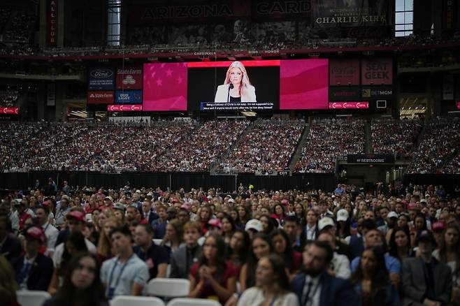 찰리 커크 추모식에서 고(故) 남편을 기리는 발언을 하는 에리카 커크의 모습이 경기장 전광판에 비치자 사람들이 귀 기울여 듣고 있다. 2025년 9월 21일(현지시간), 미국 애리조나주 글렌데일 스테이트팜 스타디움.  AP뉴시스