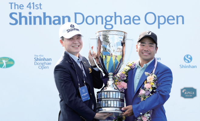 제41회 신한동해오픈에서 우승한 일본의 히가 가즈키(오른쪽)에게 진옥동 신한금융그룹회장이  트로피를 수여한 뒤  기념 촬영을 하고 있다. /사진 KPGA