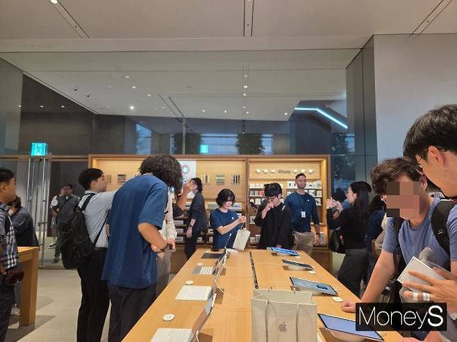 19일 서울 중구 '애플 명동' 매장 내부. 신제품을 구경하는 이들 사이로 1호 고객 김지민씨가 직원에게 제품 설명을 듣고 있다. /사진=김미현 기자