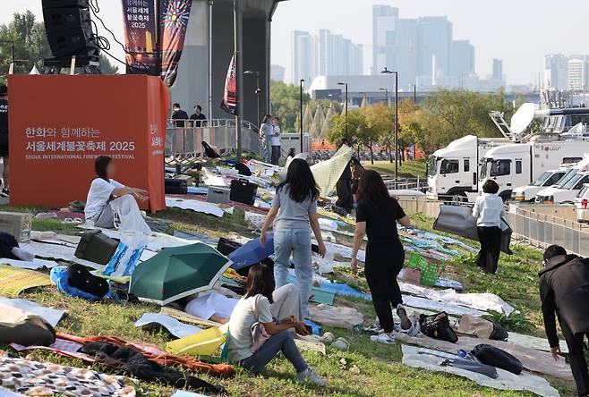 서울 여의도 한강공원 일대에서 열리는 '서울세계불꽃축제 2025'를 하루 앞둔 26일 행사장 주변에 시민들이 돗자리를 펴두고 자리를 선점하고 있다./연합뉴스