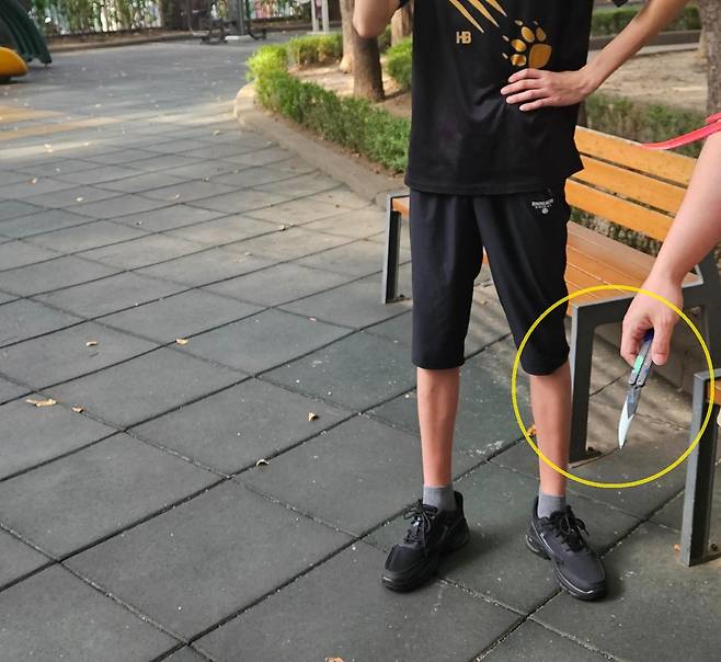 A씨가 초등학생들을 위협한 중학생에게 빼앗은 장난감 칼(노란색 원). [보배드림 갈무리]