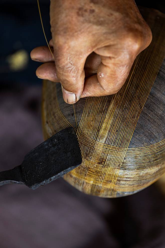 대나무에서 뽑은 죽사를 인두를 이용해 골댕이에 하나씩 붙인다. /양수열 영상미디어 기자