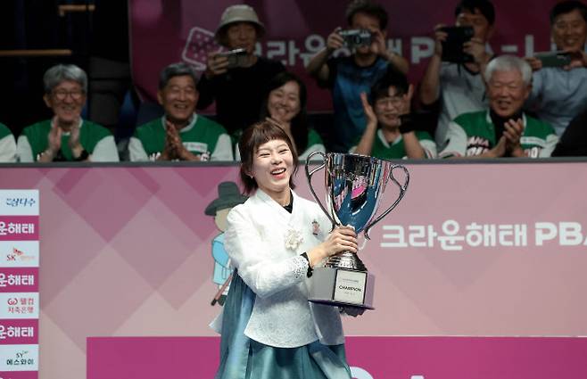 김가영이 프로당구 LPBA 한가위 대회 우승을 차지한 뒤 한복을 입고 트로피를 든 채 기뻐하고 있다. 사진=PBA
