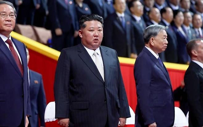 From right: Chinese Premier Li Qiang, North Korean leader Kim Jong-un and Nguyen Phu Trong, general secretary of the Communist Party of Vietnam attend a rally at Pyongyang's May Day Stadium on Thursday. (KCTV-Yonhap)