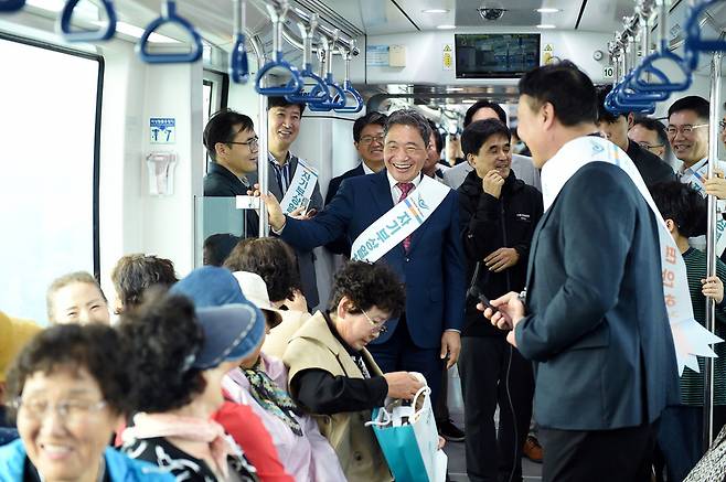 ▲ 이학재 인천공항공사 사장(가운데)이 '인천공항 자기부상열차 재운영' 행사에서 승객들과 인사를 나누고 있다. /사진제공=인천공항공사