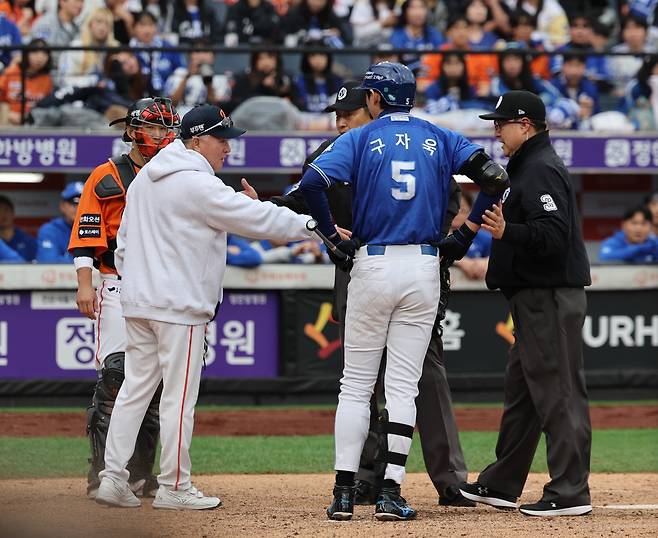 18일 대전 한화생명볼파크에서 열린 2025 KBO 포스트시즌(PS) 삼성 라이온즈와 한화 이글스의 플레이오프(PO) 1차전에서 구자욱(5번)이 한화 투수 코디 폰세의 투구 템포가 느린 것에 대해 항의하자 한화 김경문 감독(왼쪽 두 번째)이 그라운드로 나와 심판진과 얘기를 나누고 있다. 대전｜뉴시스