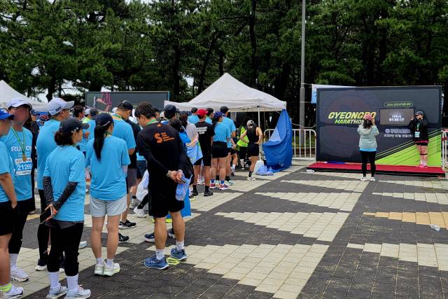 ▲ 2025 경포마라톤대회 기록 포토월에서 참가자들이 사진을 찍고 있다.
