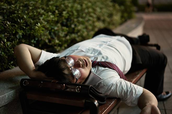 A man is passed out on a bench after drinking alcohol [GETTY IMAGES BANK]