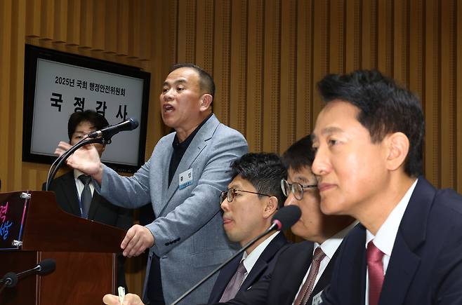 정치 브로커 명태균 씨가 23일 서울 중구 서울시청에서 열린 2025년 국회 행정안전위원회 국정감사에서 의원 질의에 답하고 있다. 오른쪽은 오세훈 서울시장. [연합]