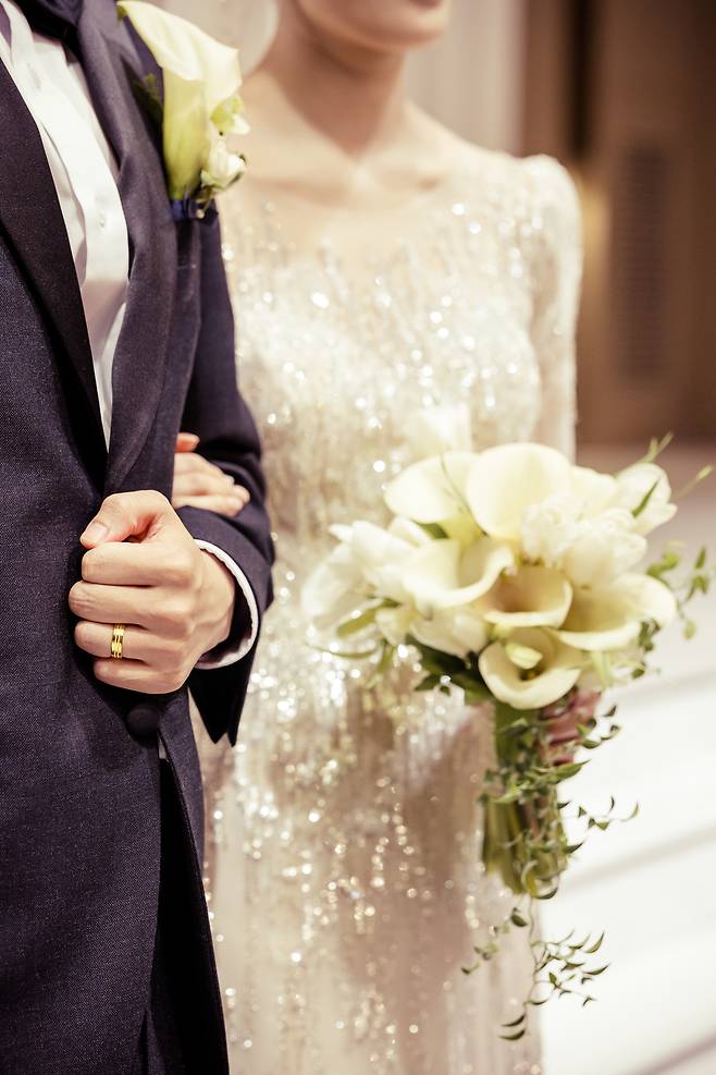 A bride and groom walk arm in arm during their wedding ceremony. (Getty Images Bank)