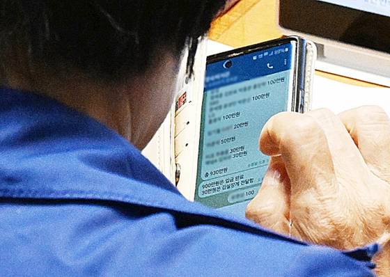 최민희 위원장이 10월 26일 국회 본회의장에서 텔레그램으로 보좌진에게 딸 결혼식 축의금 관련 메시지를 보내고 있다. [서울신문]