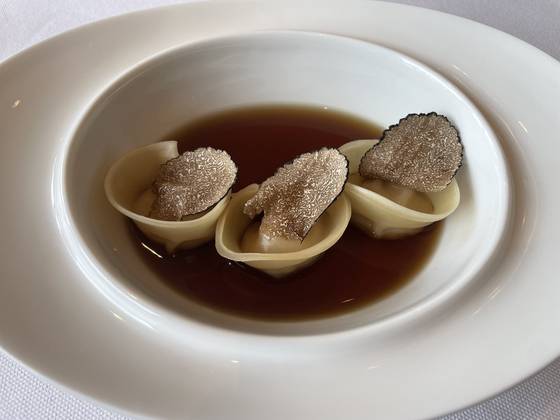 Dumplings filled with ogol (black bone) chicken sourced from Gangwon’s Yeongwol County in porcini consomme with truffle [PRESIDENTIAL OFFICE]