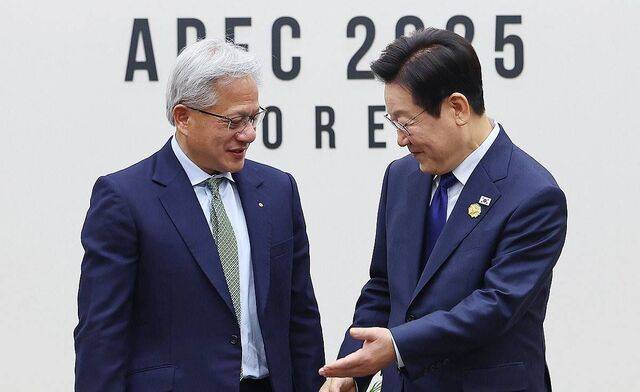 이재명 대통령이 31일 APEC 정상회의장인 경주화백컨벤션센터에서 젠슨 황 엔비디아 최고경영자와 면담 전 기념 촬영을 마친 뒤 자리를 안내하고 있다. 연합뉴스