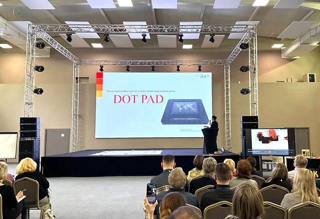 Kobessov Rakhat presents in front of an audience. [KOBESSOV RAKHAT]