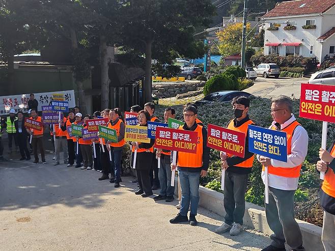 지난 6일 울릉공항 현장사무실 앞에서 주민들이 활주로 연장을 요구하며 피켓을 들고 구호를 외치고 있다. /김민정 기자