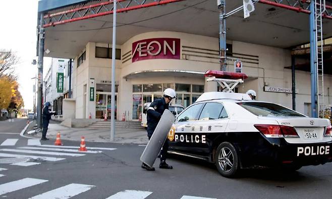 곰 출몰 신고를 받고 출동한 경찰이 16일(현지시간) 아키타현 노시로시에 위치한 대형 쇼핑몰 ‘이온 노시로점’ 앞에서 경계를 강화하고 있다. 요미우리신문 캡처