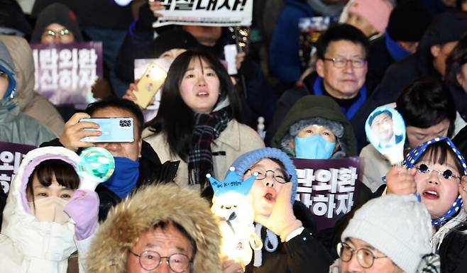 ‘12·3 내란외환 청산과 종식, 사회대개혁 시민대행진’이 열린 3일 밤 국회 정문 앞에서 참석자들이 구호를 외치며 응원봉을 흔들고 있다. 윤운식 선임기자 yws@hani.co.kr