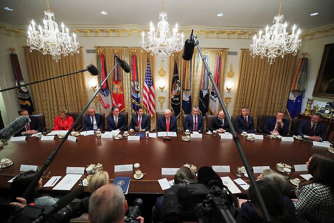 U.S. President Donald Trump, center, attends a cabinet meeting with U.S. Secretary of Defense Pete Hegseth, fifth from right, U.S. Secretary of State Marco Rubio, fifth from left, U.S. Health and Human Services Secretary Robert F. Kennedy Jr., third from left, U.S. Interior Secretary Doug Burgum, fourth from left, and U.S. Commerce Secretary Howard Lutnick, fourth from right, at the White House in Washington on Dec. 2. [REUTERS/YONHAP]