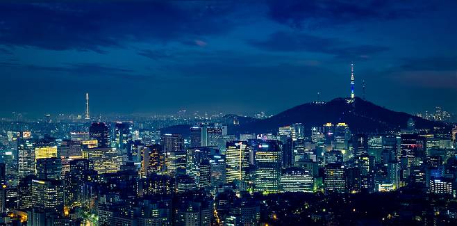 Panoramic image of Seoul downtown cityscape illuminated with lights and N Seoul Tower in central Seoul. [GETTY IMAGES BANK]