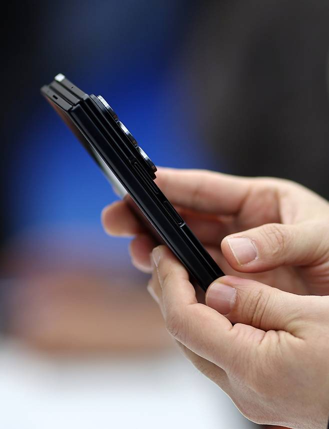 Visitors try out the Galaxy Z TriFold during Samsung Electronics’ Galaxy Z Trifold launch media day event at Samsung Gangnam in southern Seoul on Dec. 2. [YONHAP]