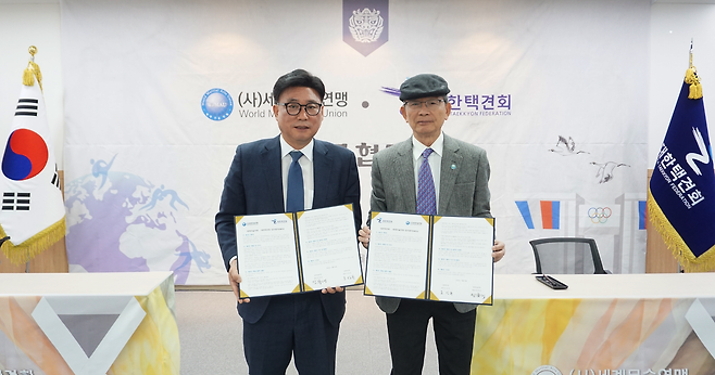 오성문(왼쪽) 대한택견회 회장과 정화태 세계무술연맹 총재가 4일 업무협약 뒤 기념촬영을 하고 있다.