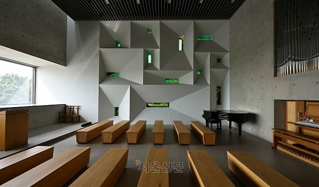 인천 강화 ‘멍때림 채플’의 예배당 모습. 벽면이 열두 제자를 상징하는 열두 개 스테인드글라스로 장식됐다. 왼쪽 통창으로는 강화 갯벌이 눈에 담긴다.