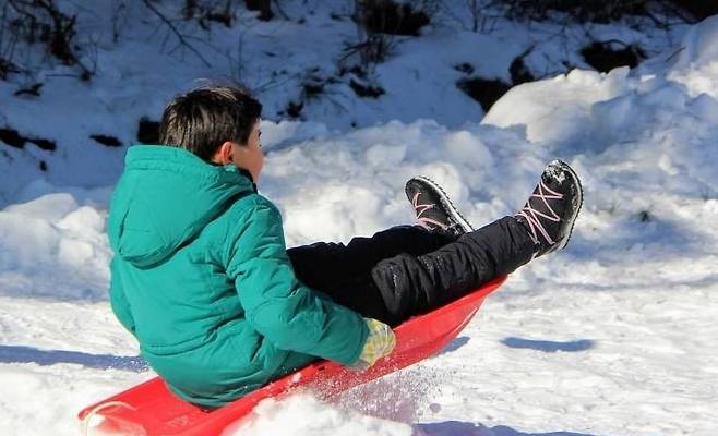 양평빙송어축제장 인근에서 눈썰매를 타고 있는 아이. /수미마을