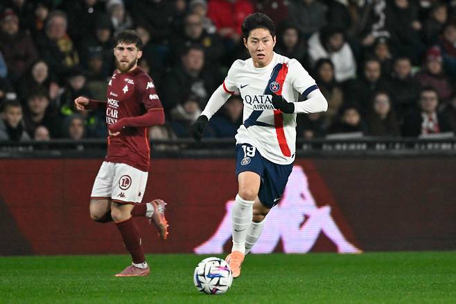 <yonhap photo-0855=""> Paris Saint-Germain's South Korean midfielder #19 Lee Kang-in controls the ball during the French L1 football match between Metz and Paris Saint-Germain (PSG) at the Stade Saint-Symphorien in Metz, eastern France, on December 13, 2025. (Photo by Jean-Christophe VERHAEGEN / AFP)/2025-12-14 04:39:14/ <저작권자 ⓒ 1980-2025 ㈜연합뉴스. 무단 전재 재배포 금지, AI 학습 및 활용 금지></yonhap>