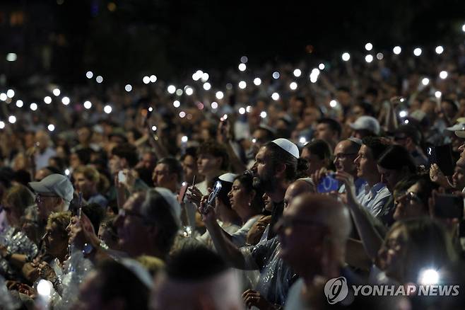 추모의 불빛 밝힌 시드니 유대인 총격테러 애도행사 참석자들 (시드니 로이터=연합뉴스) 호주 시드니 유대인 대상 총격테러 사건 추모일인 21일(현지시간) 시드니 본다이 비치 해변에서 열린 추모 행사에서 참가자들이 희생자를 애도하는 불빛을 밝히고 있다.