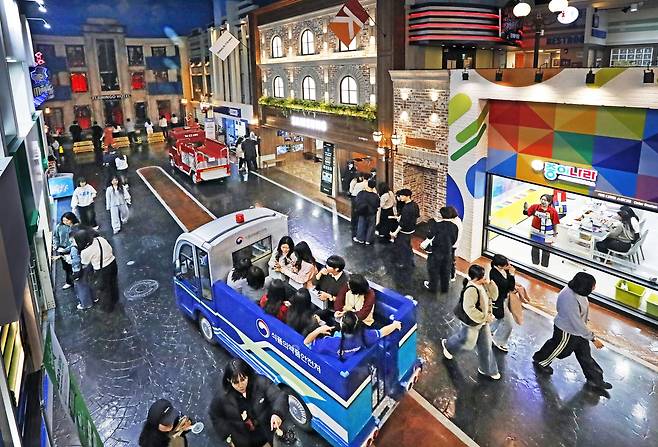 Adult participants take over the usually children-only theme park KidZania for a single-day, adult-only event in Jamsil, southern Seoul, on Dec. 20. [PARK SANG-MOON]