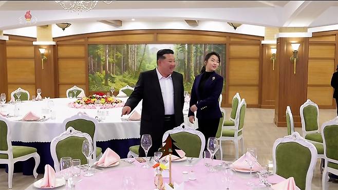 North Korean leader Kim Jong-un, left, tours the restaurant facilities with his daughter, Kim Ju-ae, during the completion ceremony of the Milyong Hotel in Samjiyon on Dec. 20. [KOREAN CENTRAL TELEVISION]