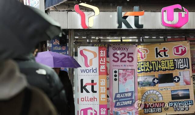 휴대전화를 개통할 때 얼굴 사진을 찍어 본인을 확인받는 절차가 시범 실시되기 시작한 지난 23일 한 휴대폰 매장 앞을 시민들이 오가고 있다. 연합뉴스