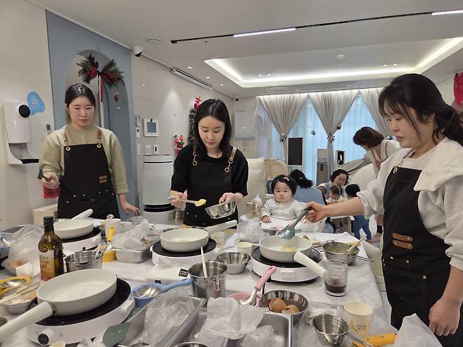 경북 예천군 도청신도시의 한 아파트 1층에 마련된 공동육아나눔터 ‘0세 특화반’에 참여한 엄마들이 지난 23일 이유식 만들기 수업을 듣고 있다. 엄마들이 수업을 받는 동안 아기들은 전문 돌봄교사가 돌본다.