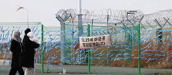 사고가 발생한 무안국제공항 현장에는 추모객들이 매단 추모 리본이 걸려 있고, 시민들은 이를 바라보며 희생자들을 추모하고 있다. /임문철 기자 35mm@namdonews.com