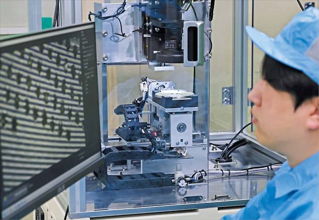 지난 24일 인천 남동구 신한다이아몬드공업 1공장 검사실에서 작업자들이 현미경을 통해 초미세 다이아몬드를 살펴보며 불량 여부를 찾아내고 있다.(위쪽 사진). 다른 한쪽에서는 연구원 한 명이 실물보다 150배 확대한 화면을 통해 작업자들이 찾아낸 불량 사례를 분석하며 데이터를 모으고 있다.(아래쪽 사진)./장경식 기자